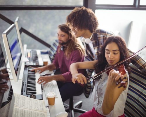 Three sound engineers working together in the studio